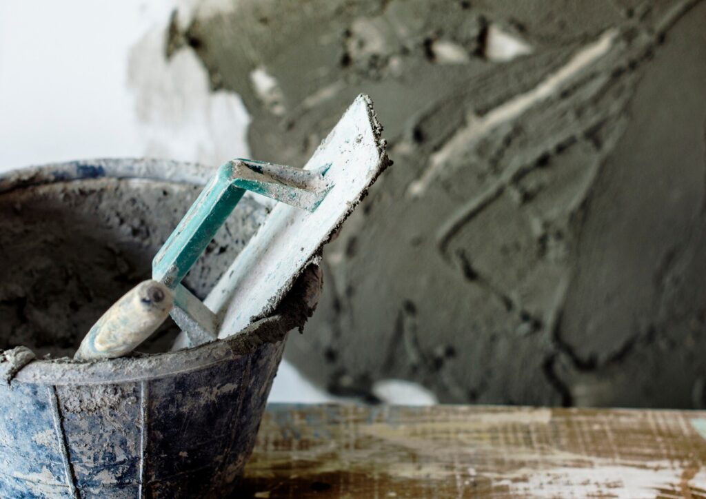 Cement mix and tools prepared for void filling beneath concrete slab in Garland, TX