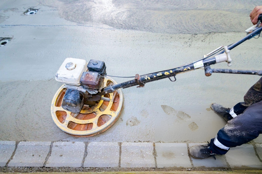 Power trowel finishing concrete surface after compaction grouting in Garland, TX