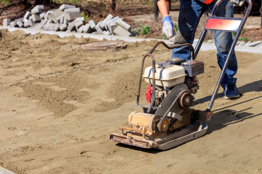 Soil compaction with plate compactor preparing base for grouting in Garland, TX
