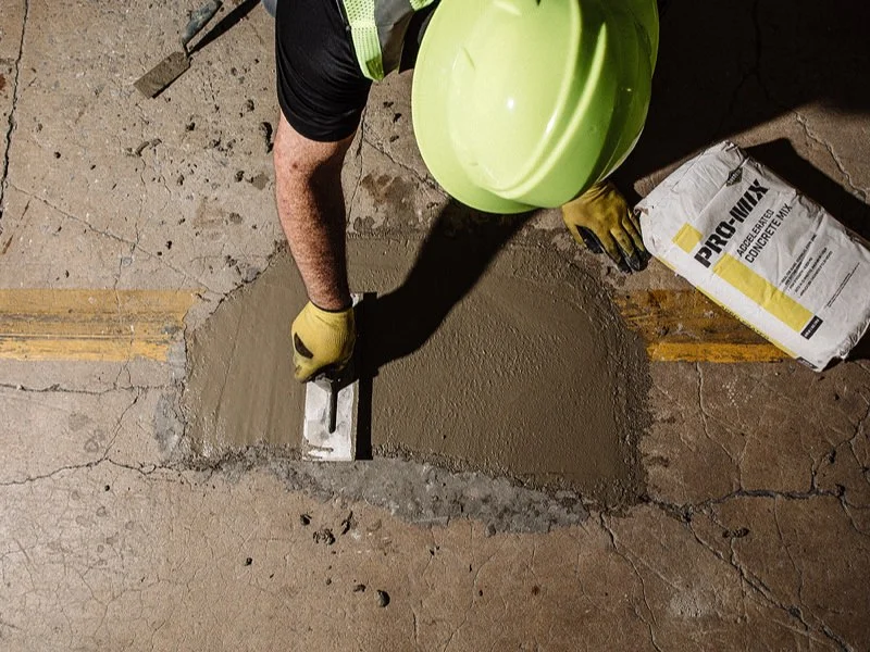 Contractor performing concrete slab foundation repair in Garland, TX using Pro-Mix concrete