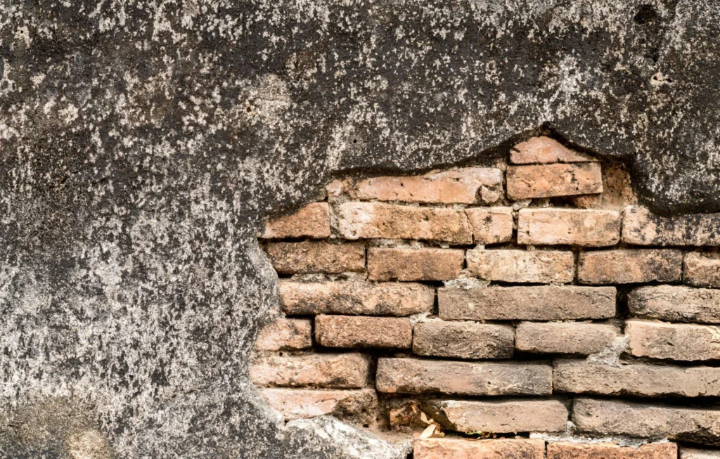 Deteriorated brick wall with crumbling mortar requiring structural wall repair in Garland, TX