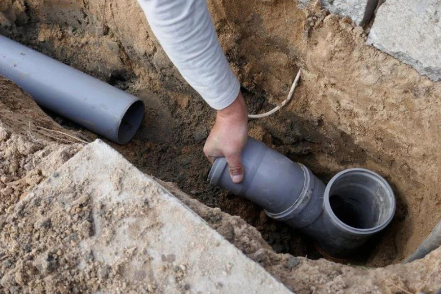 Drainage services and repair in Garland, TX with new PVC pipe installation in trench