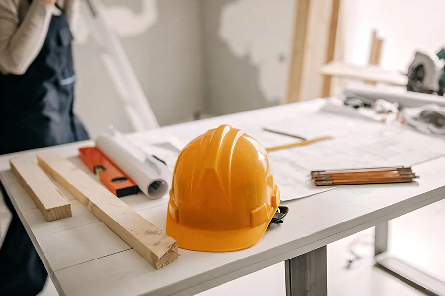 House leveling project planning with blueprints and construction tools in Garland, TX