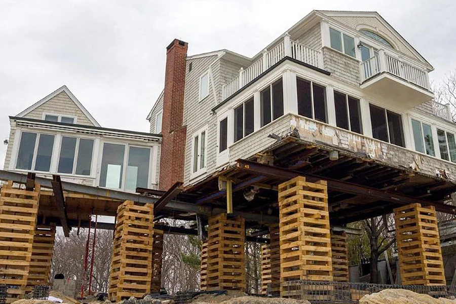 House Raising / Lifting in Garland, TX with coastal home elevated on wooden cribbing