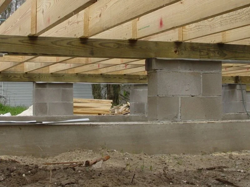 Block and base foundation repair in Garland, TX with concrete cinder block piers supporting wood framing