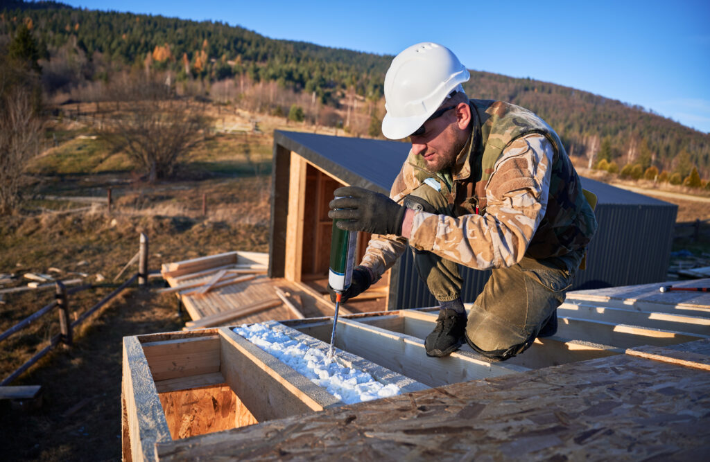 Contractor applying polyurethane foam insulation during construction project in Garland, TX