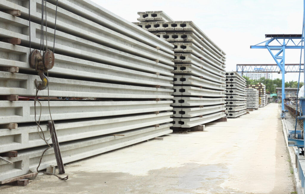 Precast pressed concrete pilings stored at facility for foundation projects in Garland, TX