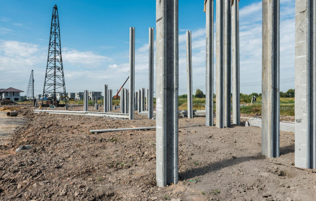 Rows of pressed concrete pilings installed for foundation support in Garland, TX