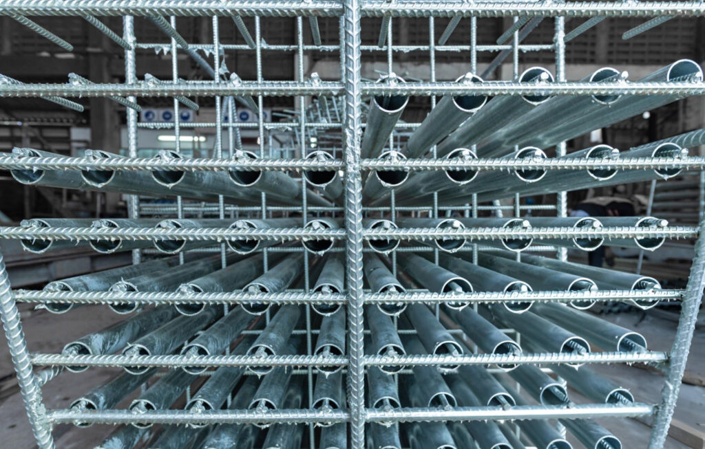 Pressed steel pilings installation in Garland, TX with reinforced steel piling cages at facility