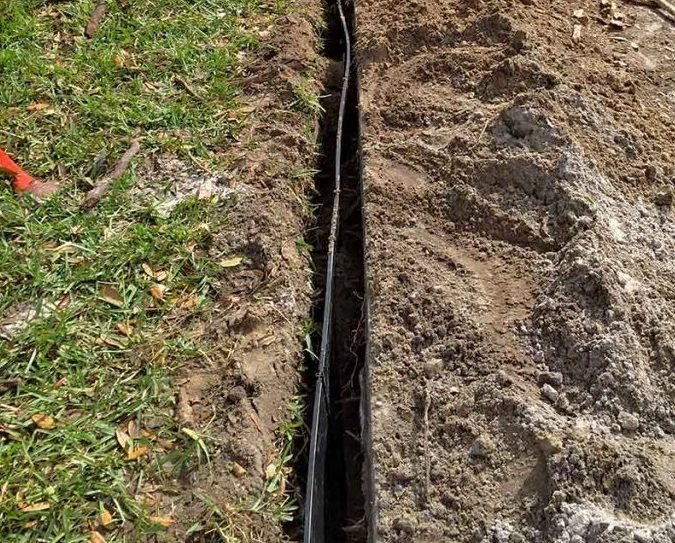 Root barrier fabric installed in trench to protect foundation from tree roots in Garland, TX