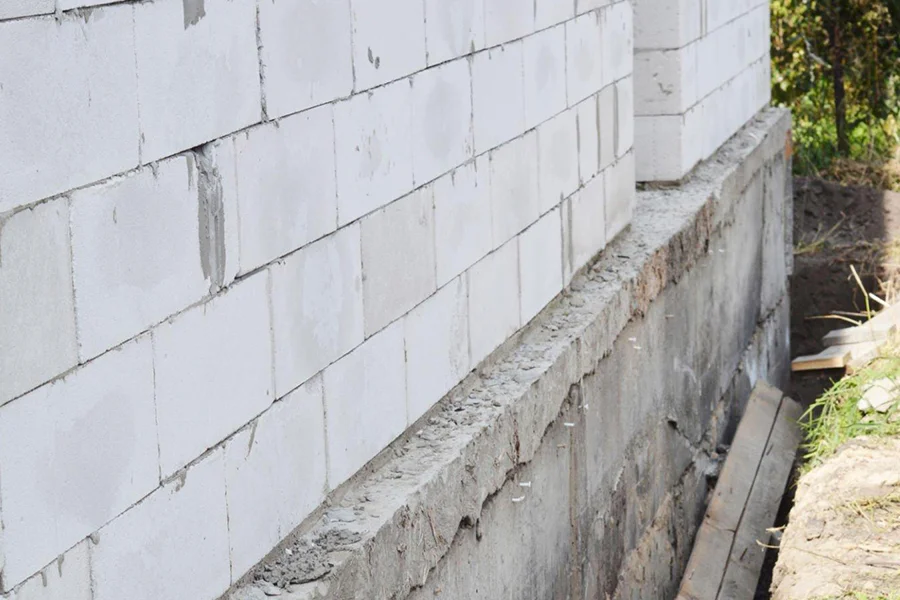 Exposed concrete slab foundation showing pier installation access point in Garland, TX