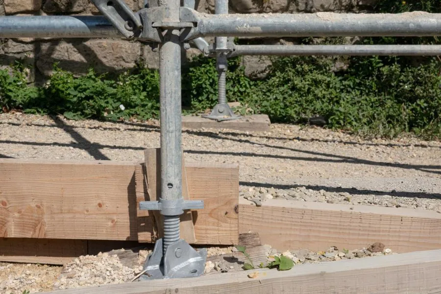 Adjustable steel pier supports stabilizing foundation during push pier installation in Garland, TX